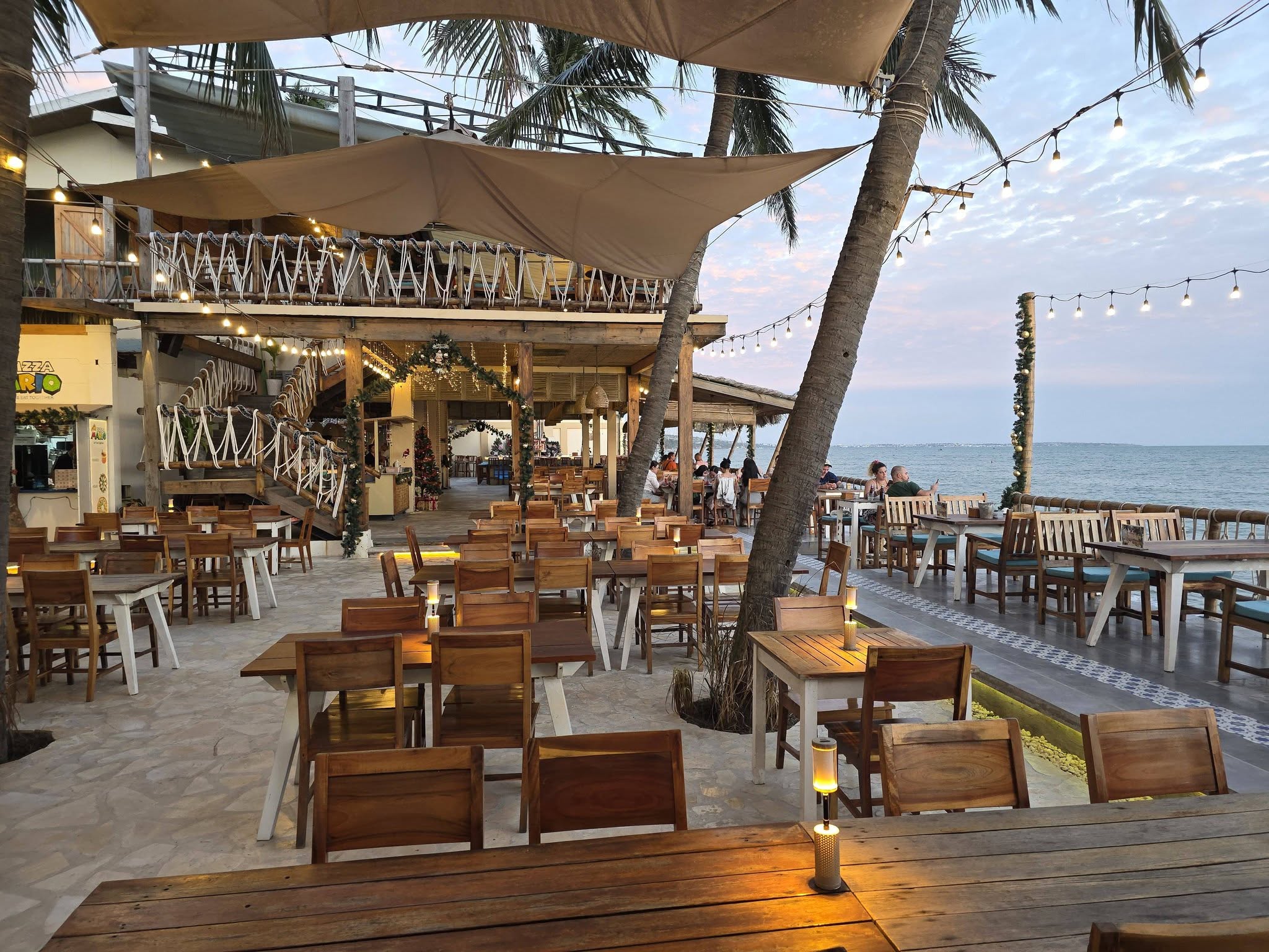 Open-air seafood restaurant seating beside the water at Bo Ke, Mui Ne