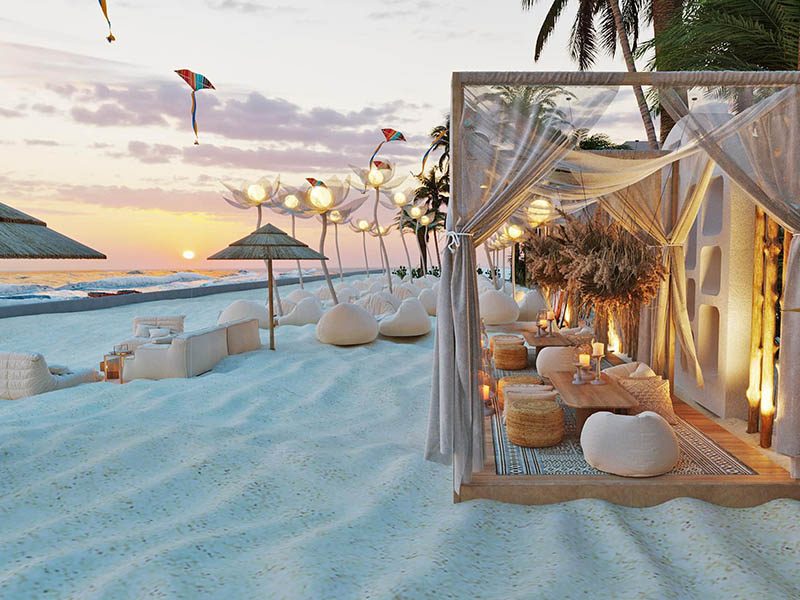 In the Hanna Beach section — open-air beachfront seating and loungers