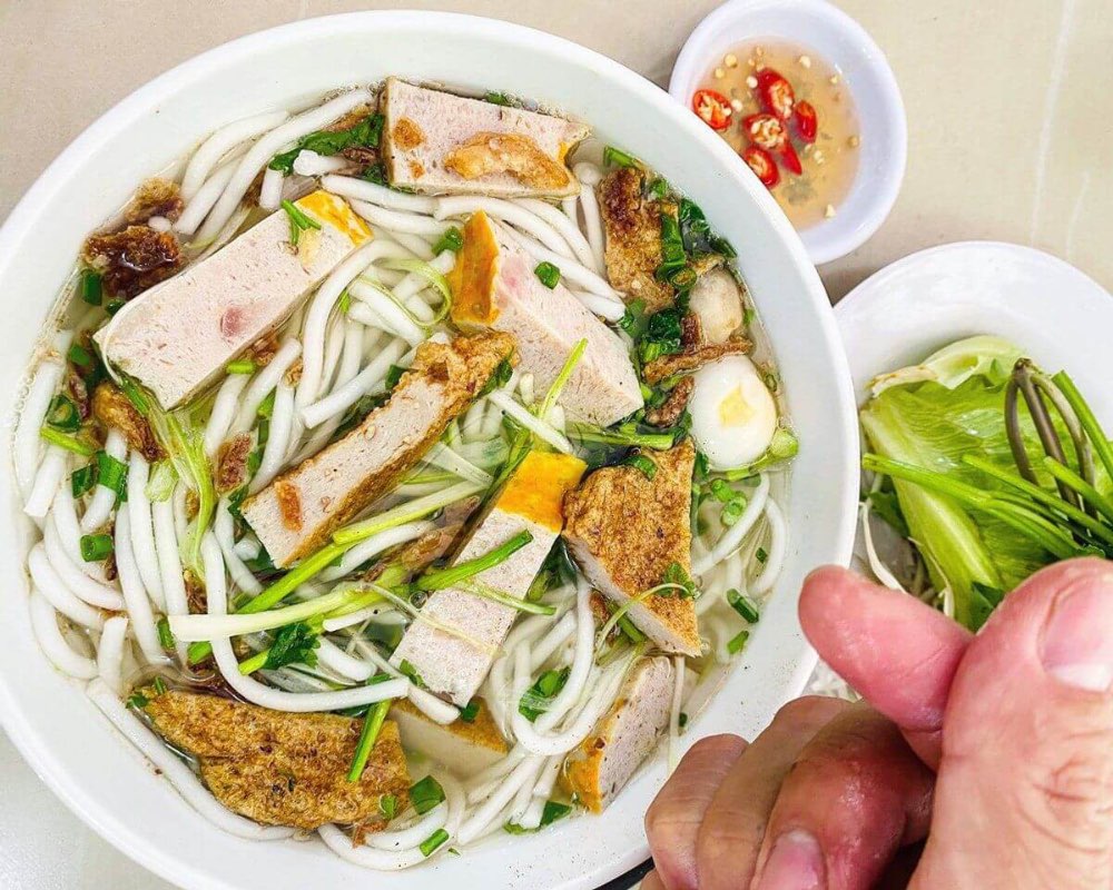 Inside section 1, banh canh cha ca — bowl of fish cake noodle soup with clear broth