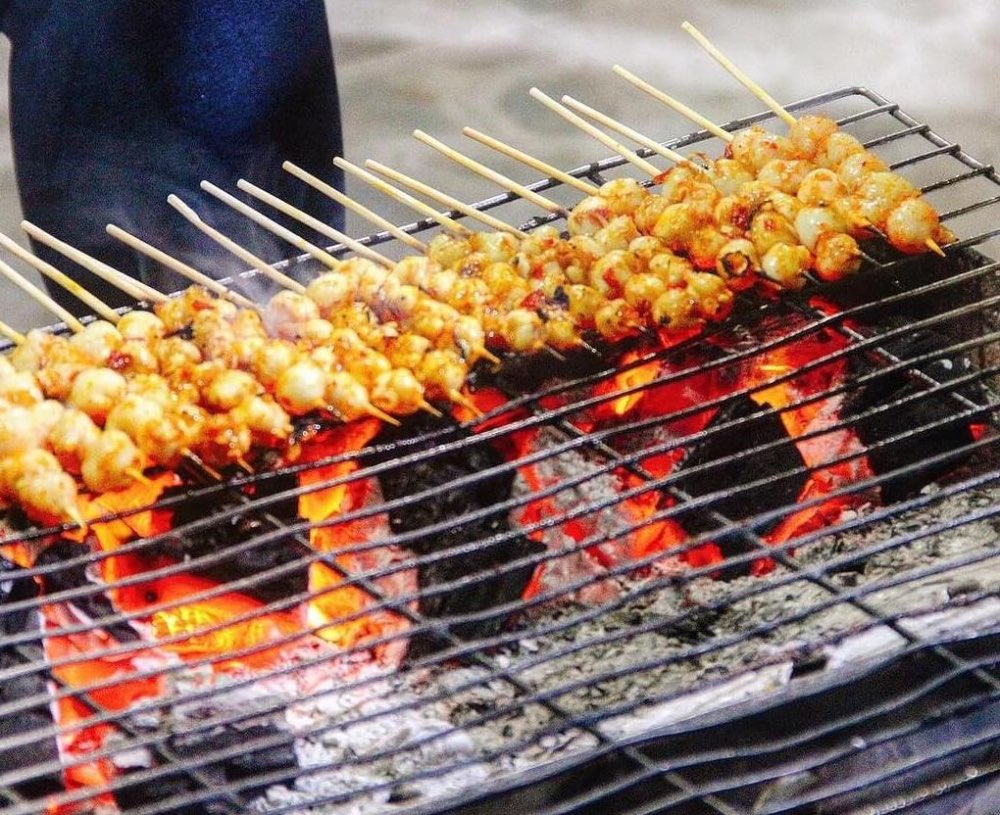 Inside section 3, rang muc nuong — charcoal-grilled squid teeth on the grill