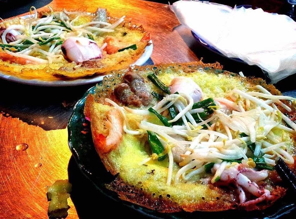 Inside section 10, banh xeo tom muc — small crispy shrimp and squid crepes